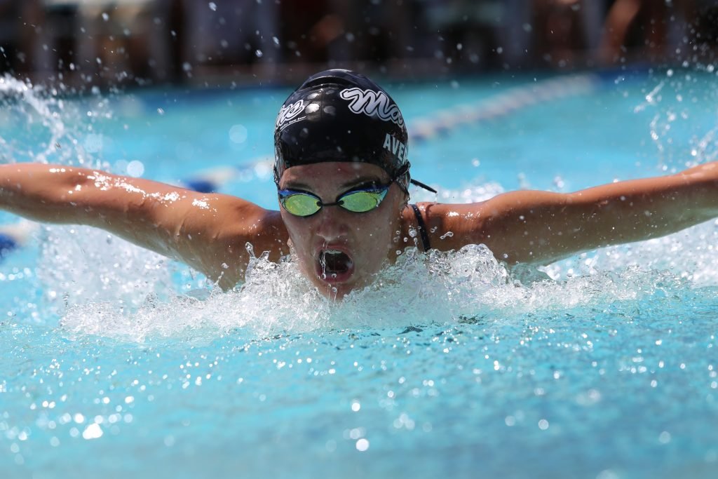 Person in swimming goggles in swimming pool